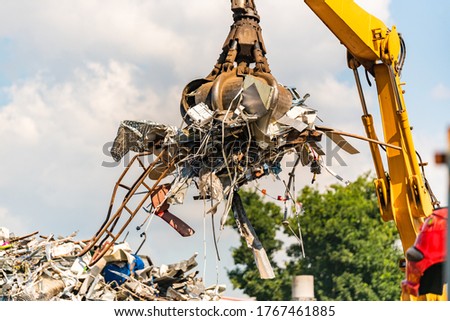 Close-up of a crane for recycling metallic waste on scrapyard Royalty-Free Stock Photo #1767461885