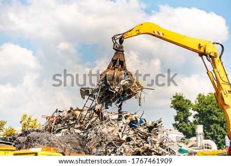 Close-up of a crane for recycling metallic waste on scrapyard Royalty-Free Stock Photo #1767461909
