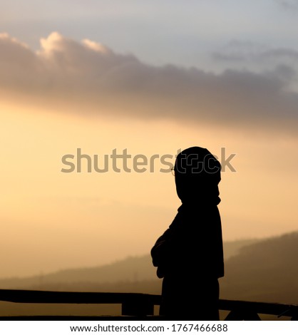the silhouette of the veiled woman