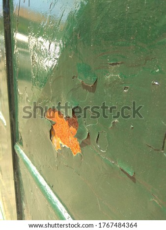 Flaking paint on the gate close up