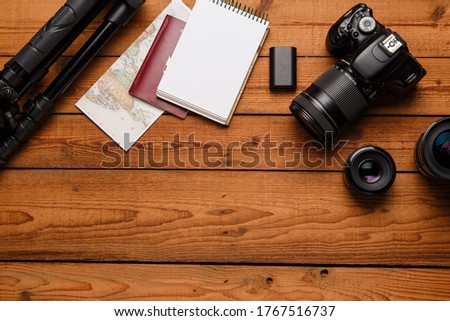 top view of travel photographic equipment on wooden background, Top view of diverse personal equipment for photographer or creative designer, copy space