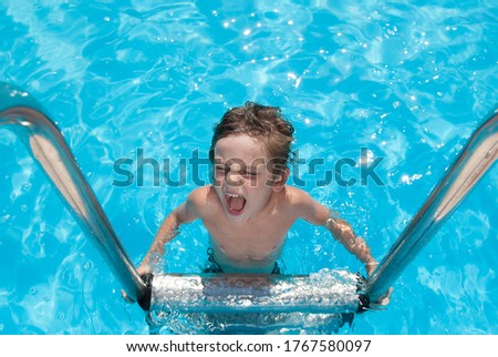 happy delightful little boy shouting on water blue pool chrome handrail during recreation leisure summer activity
