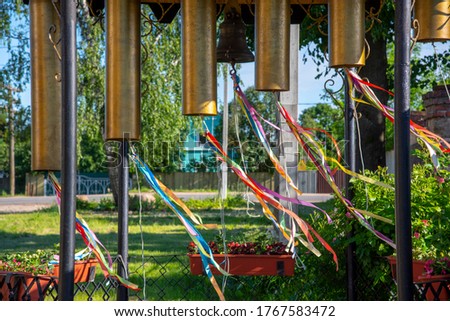 Bells of unusual shape decorated with colored silk ribbons that flutter in the wind.