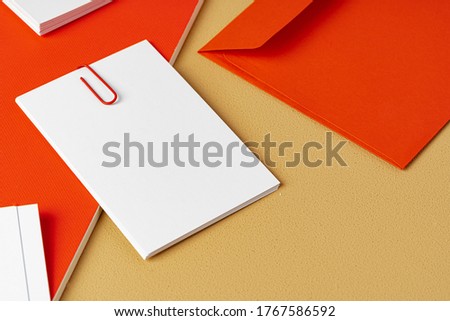 Red and white blank branding paper on beige background