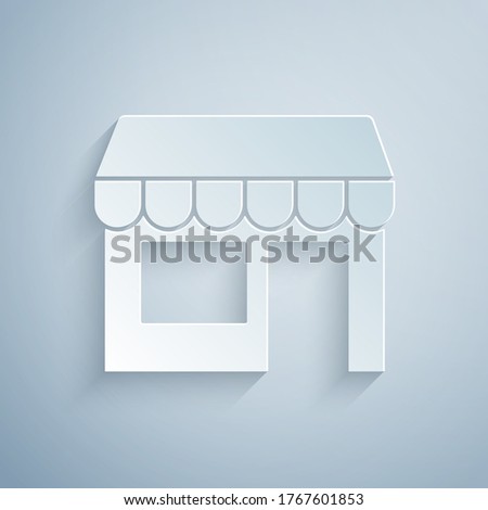 Paper cut Shopping building or market store icon isolated on grey background. Shop construction. Paper art style. Vector