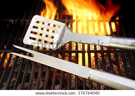 BBQ Utensils lie on the Hot cast iron grate surrounded by flame, you can also see more pictures of BBQ on my page