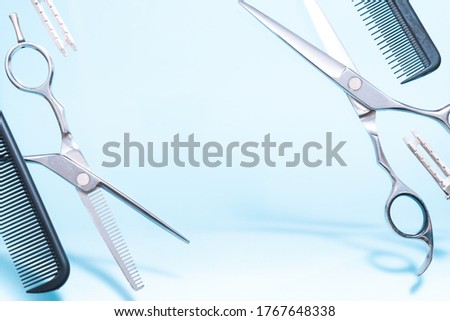 Flying hairdresser tools comb, scissors under trendy color background with copy space and soft light. Stylish Professional Barber Scissors, Hairdresser salon concept, Haircut accessories.