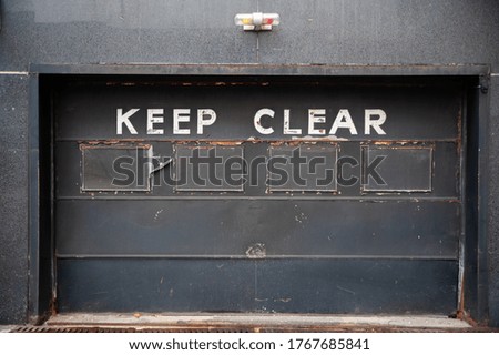 Keep Clear Letters written on dark Gate