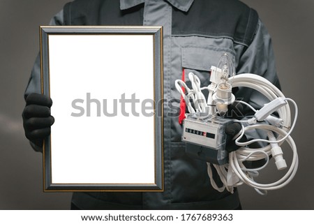Best electrician award template. Electrician with blank diploma certificate and work tools in hands close up.
