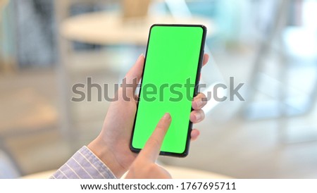 Close Up of Female Hand using Smartphone with Chrome Key Screen