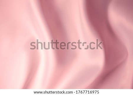 Cosmetic silky cream texture pink colored background