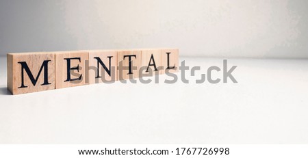 Mental health text from wooden cubes. Photo was taken in spot light on white background. Consept about health.