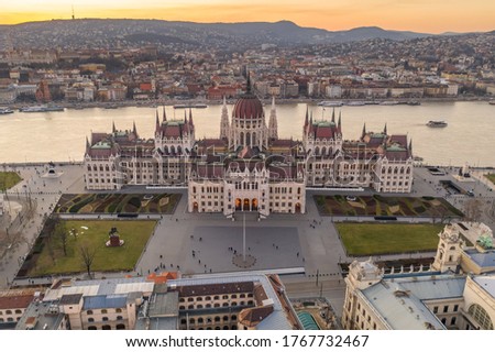 Aerial drone shot of Hungarian Parliament by Danube river in Kossuth Square in Budapest sunset Royalty-Free Stock Photo #1767732467