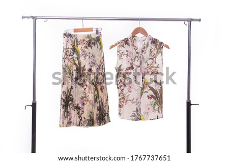 Female floral Leaves , pattern blouse and skirt on hanger