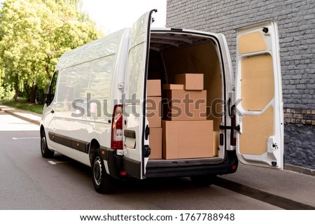 white van  with delivery packages Royalty-Free Stock Photo #1767788948