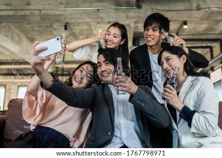 Group of men and women taking pictures