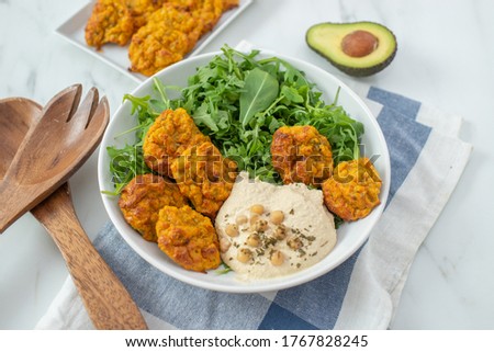 healthy superbowl or Buddha bowl with salad, baked sweet potatoes