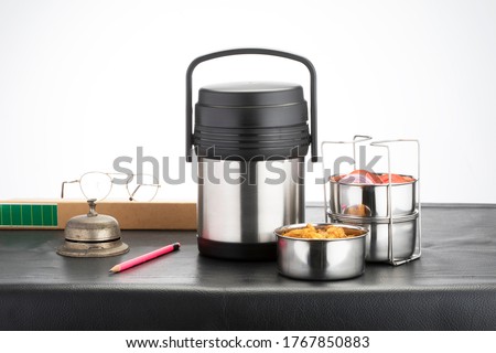 Lunch box, tiffin box with appetizing food  on table against white background
 Royalty-Free Stock Photo #1767850883