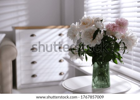 Bouquet of beautiful peony flowers on table indoors. Space for text