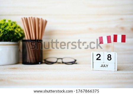 July 28 Wooden calendar and Peru Flag Concept Peru national day with space for your text