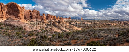 Stunning panorama of Garden of Eden sandstone rock formations on a sunny day with beautiful cloudscape, Arches National Park, Moab, Utah