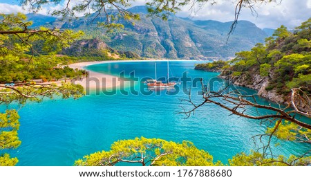 Brown gulet anchored at the Aegean sea - Panoramic view of Oludeniz Beach And Blue Lagoon, Oludeniz beach is best beaches in Turkey - Fethiye, Turkey Royalty-Free Stock Photo #1767888680