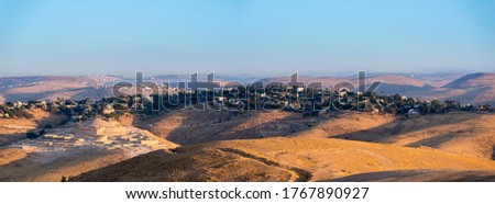 Construction site at Kfar Adumim, a mixed religious-secular Israeli settlement in the Mateh Binyamin Region of the West Bank, surrounded by hills of Judean Desert, in the light of morning sun Royalty-Free Stock Photo #1767890927