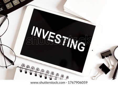 INVESTING/ Business Concept on white background with office tools