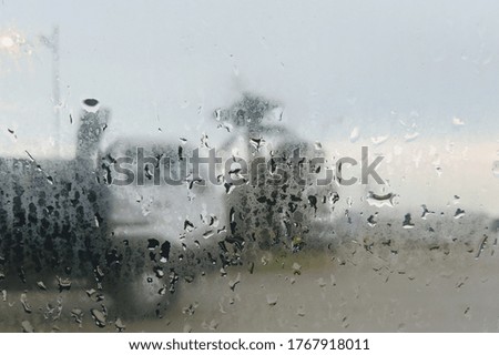water droplets with abstract blur background as viewed from car window on a rainy day. selective focus.