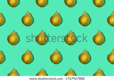 Bright seamless photo pattern of yellow pear on green background top view.
