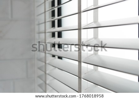 Close-up open venetian blinds. lighting range control sunlight coming from a window. decoration interior. Modern jalousie. Royalty-Free Stock Photo #1768018958