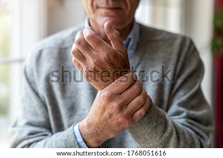 Senior man with arthritis rubbing hands
 Royalty-Free Stock Photo #1768051616