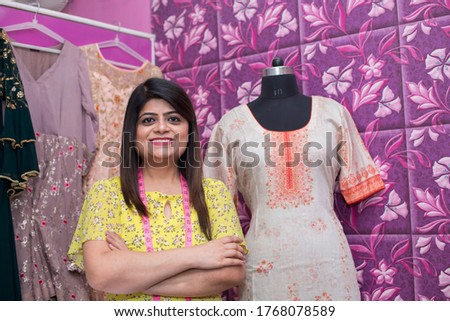 Beautiful woman standing with arms crossed in a fashion store