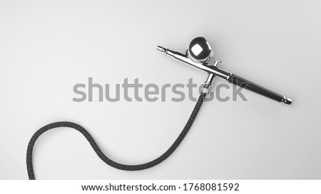 Isolated precision airbrush from chrome with black grip. White background with hose. Royalty-Free Stock Photo #1768081592