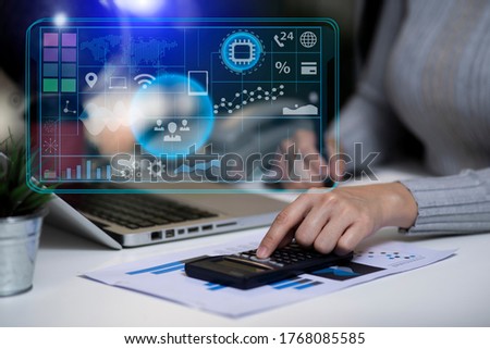  businesswoman working on calculator with digital marketing virtual chart, Abstract icon, Business strategy concept, Background toned image blurred.