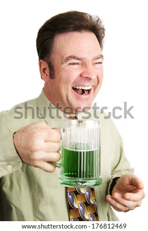 Irish American man celebrating St. Patrick's Day with a green beer and laughing.  Isolated on white.  