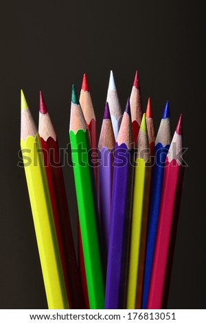 An image of multi-coloured pencils on a black background