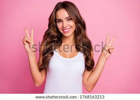 Hi guys Photo of pretty wavy lady hold fingers arms showing v-sign symbol greeting friends street wear white casual tank-top isolated pink color background