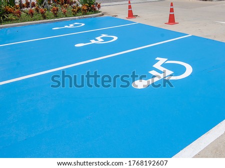 Close picture of Handicapped parking spot, white on blue asphalt