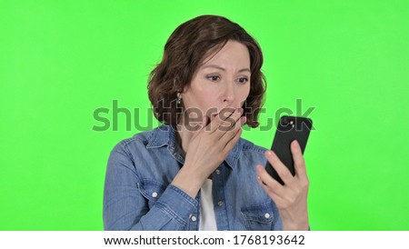 Old Woman with Loss on Smartphone, Green Chrome Key Background