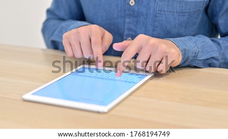 of Writing on Tablet by Male Hands