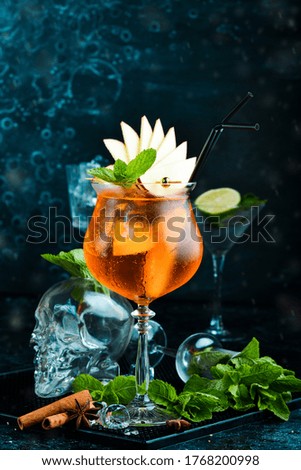 Cocktail in a glass - Aperol spritz. on a black stone background. Menu bar. Alcohol.