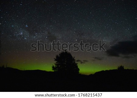 Aurora Australis and starry night in the rural area of Te Anau Downs, New Zealand. 