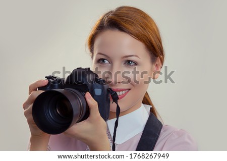Photographer. Closeup portrait headshot young woman lady girl smiling taking pictures holding dslr camera. Wedding travel photography hobby paparazzi. Mixed race model isolated light green background Royalty-Free Stock Photo #1768267949