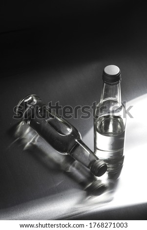 sparkling water in glass with lemon near two defferent lable bottle of water