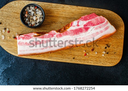smoked bacon piece of meat and fat Menu concept serving size. food background top view copy space for text organic healthy eating raw