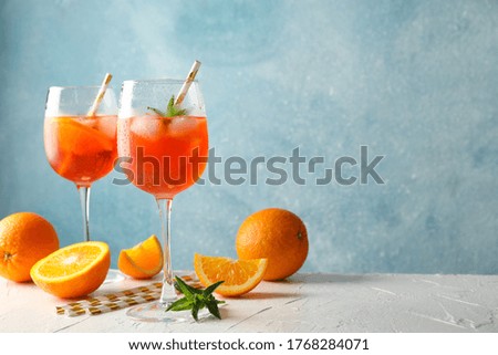 Composition with aperol spritz cocktail against blue background Royalty-Free Stock Photo #1768284071