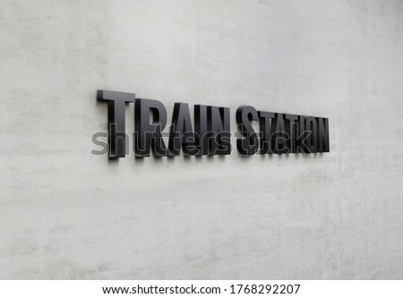 A building metal signage that says 'Train Station'.