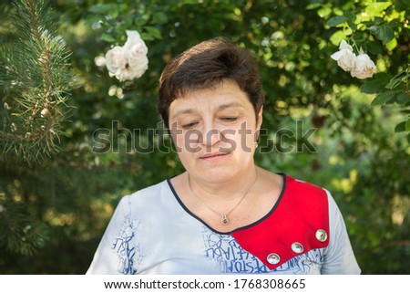 Picture of a middle-aged woman. Concept of emotions. Woman is happy to have rest outdoors after quarantine is relaxed.
