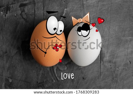 Two eggs of white and brown color with cartoon faces on a dark background. The concept of creating a family, love, a first date. Copy space